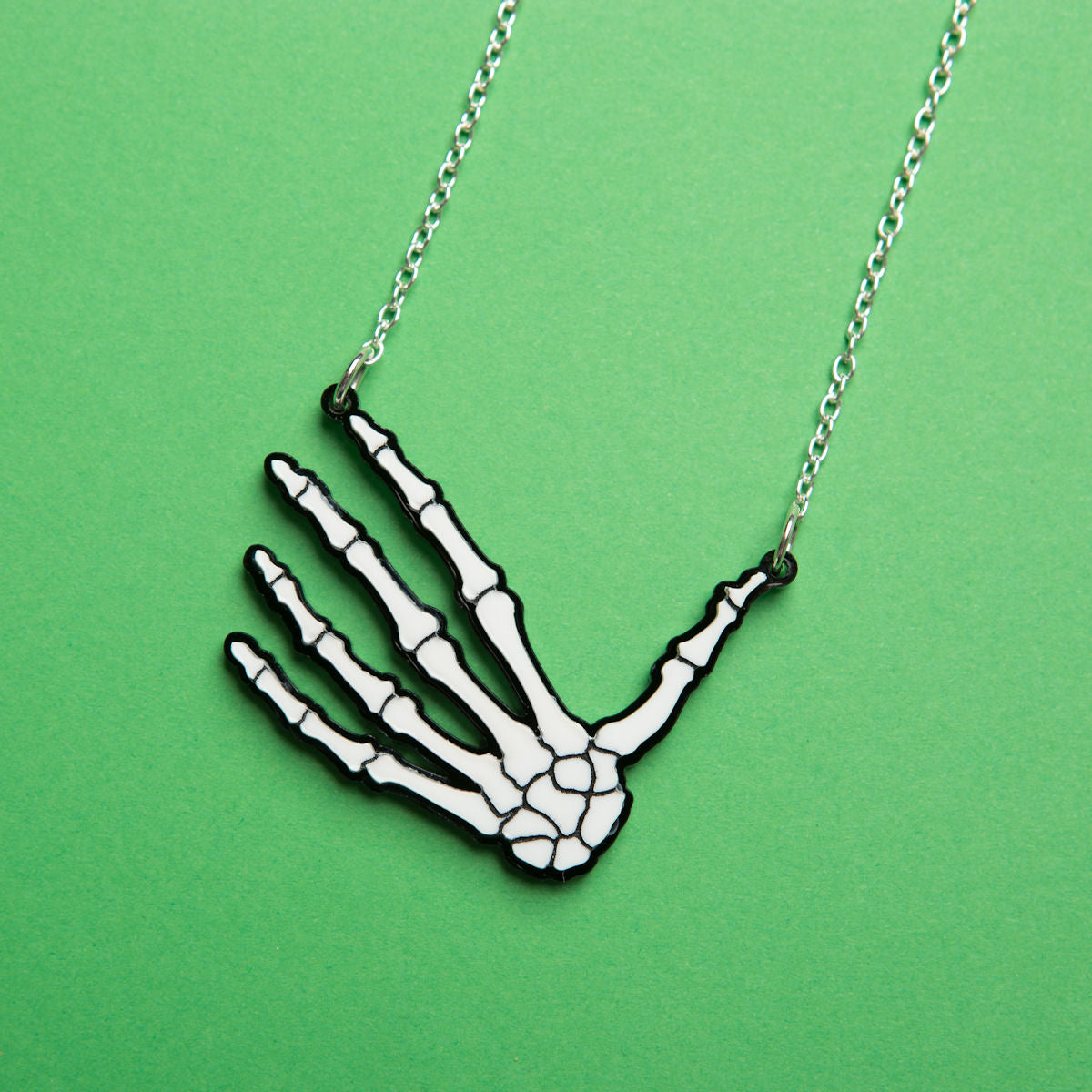 Sugar & Vice mini skeleton hand necklace social media